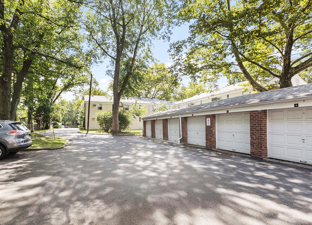 a garage with a car parked in front of a house
