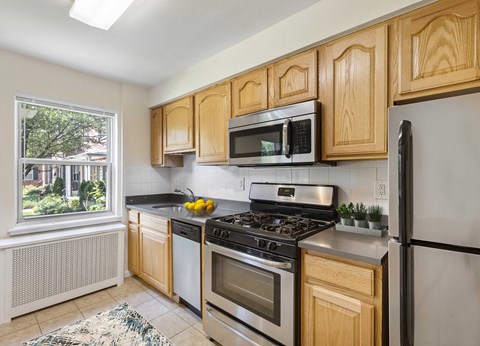 a kitchen with stainless steel appliances and wooden cabinets