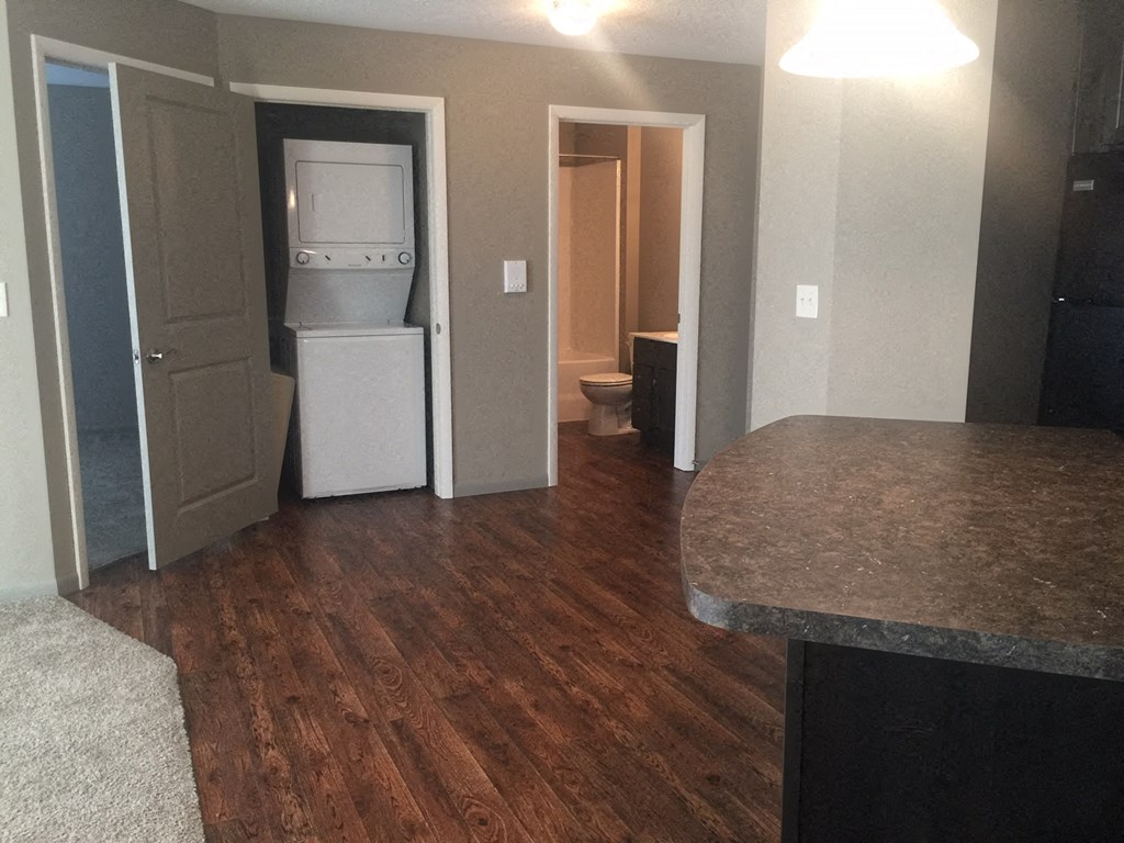 a kitchen with a refrigerator and a washer and dryer