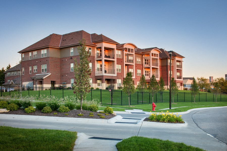 an exterior view of an apartment building with a fire hydrant