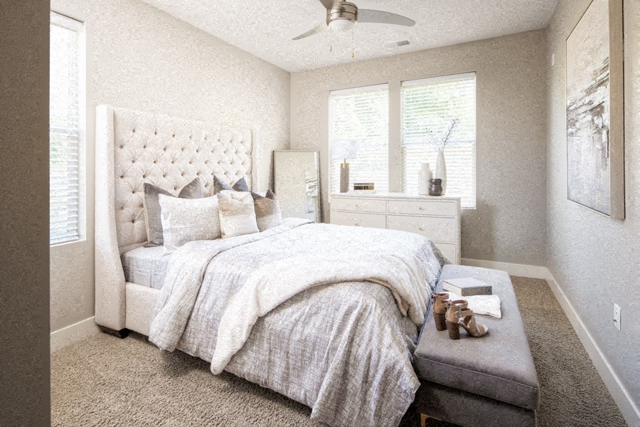 a bedroom with a bed and a dresser