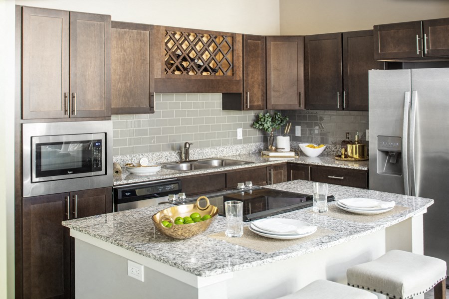 a modern kitchen with stainless steel appliances and granite counter tops