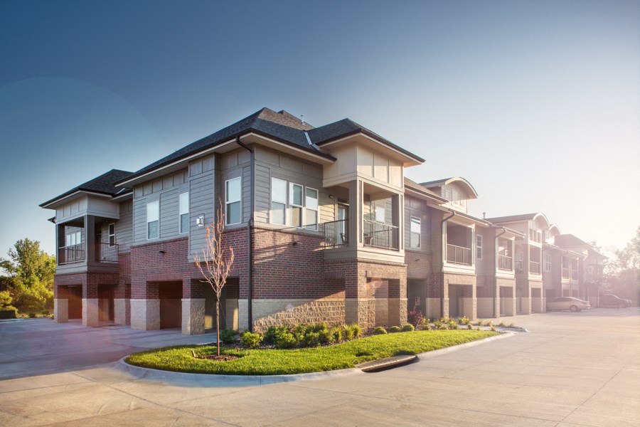a row of houses with a street in front of them