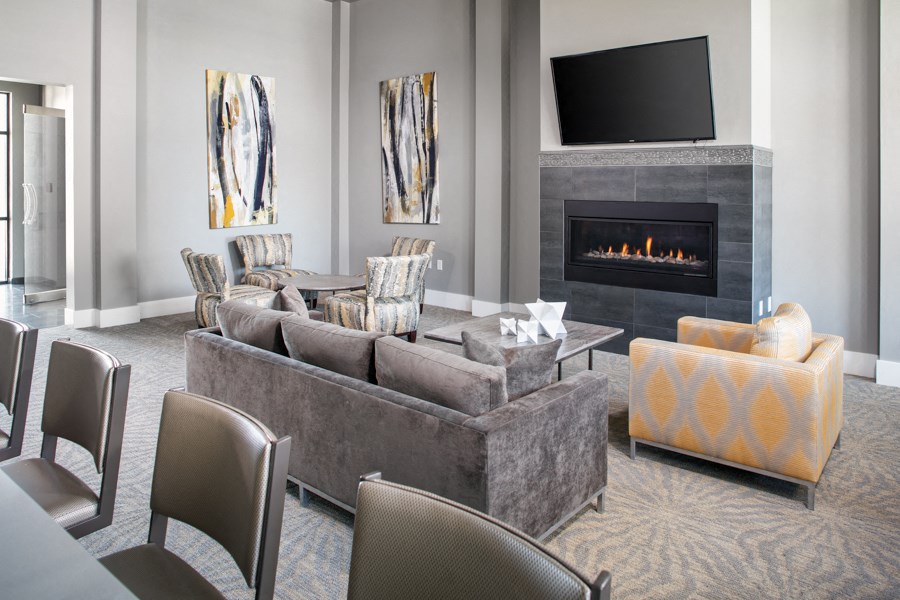 a living room with a couch and chairs and a fireplace