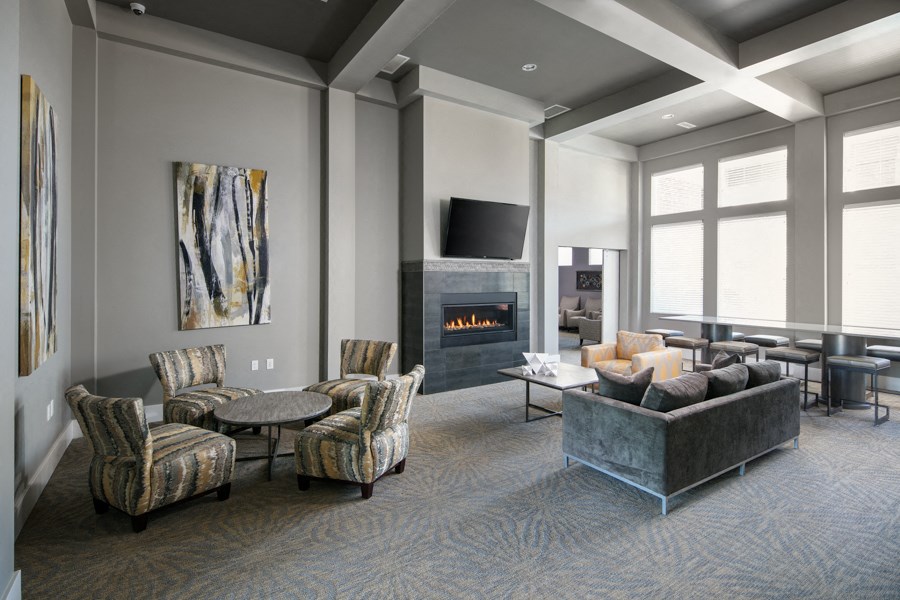 a living room with couches and chairs and a fireplace