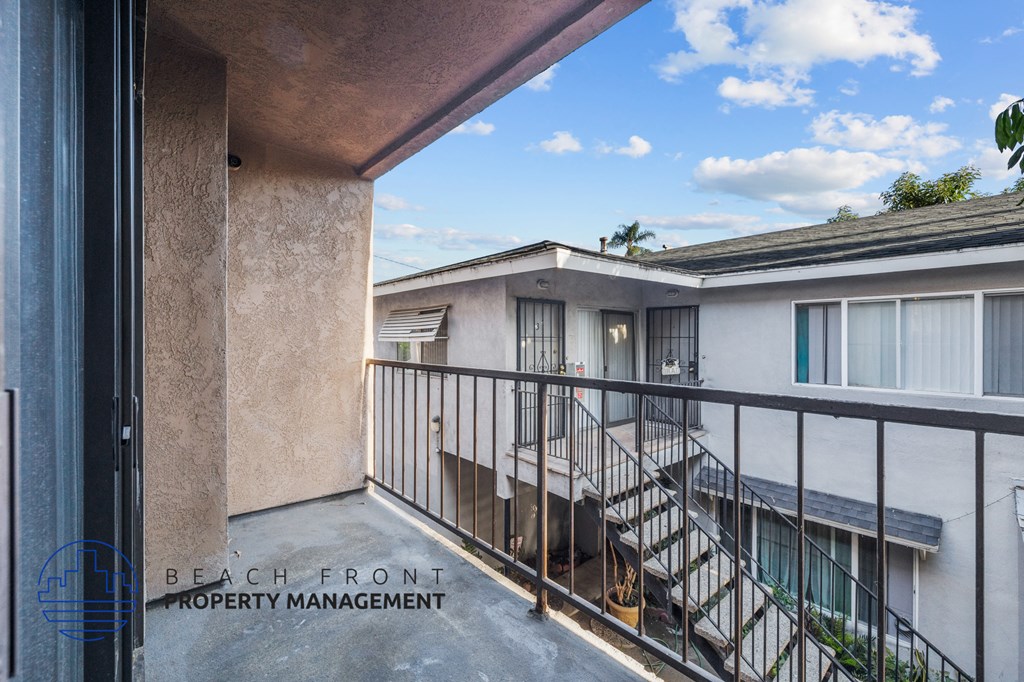 a balcony with a view of a building and a staircase