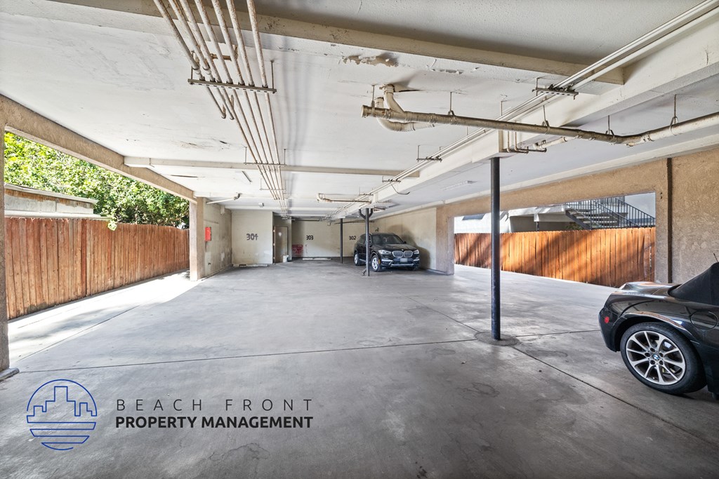 a parking garage with cars in it and a wooden wall