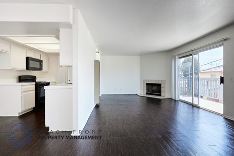 A spacious living room with a fireplace and sliding glass doors.