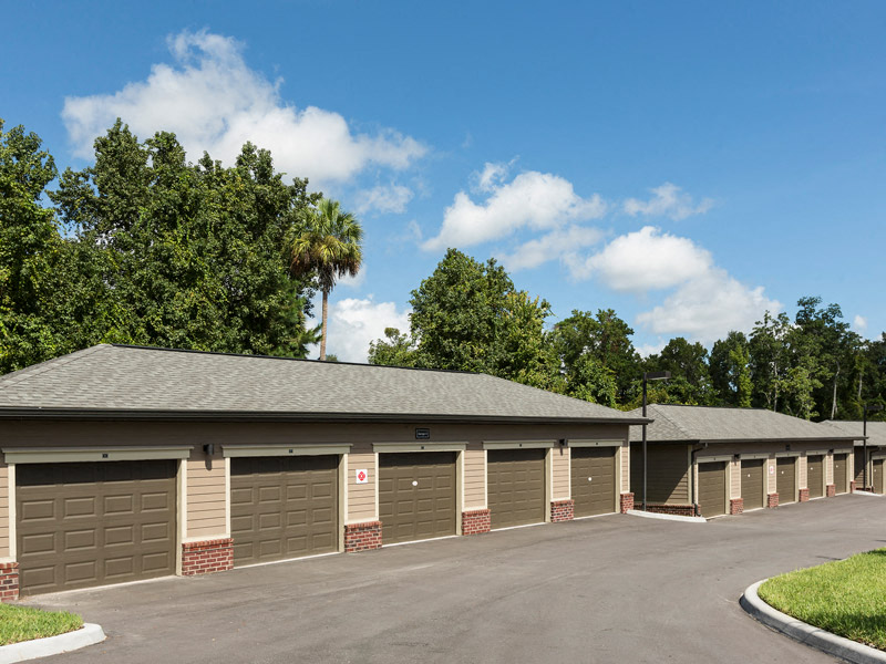 a row of garages in front of a parking lot