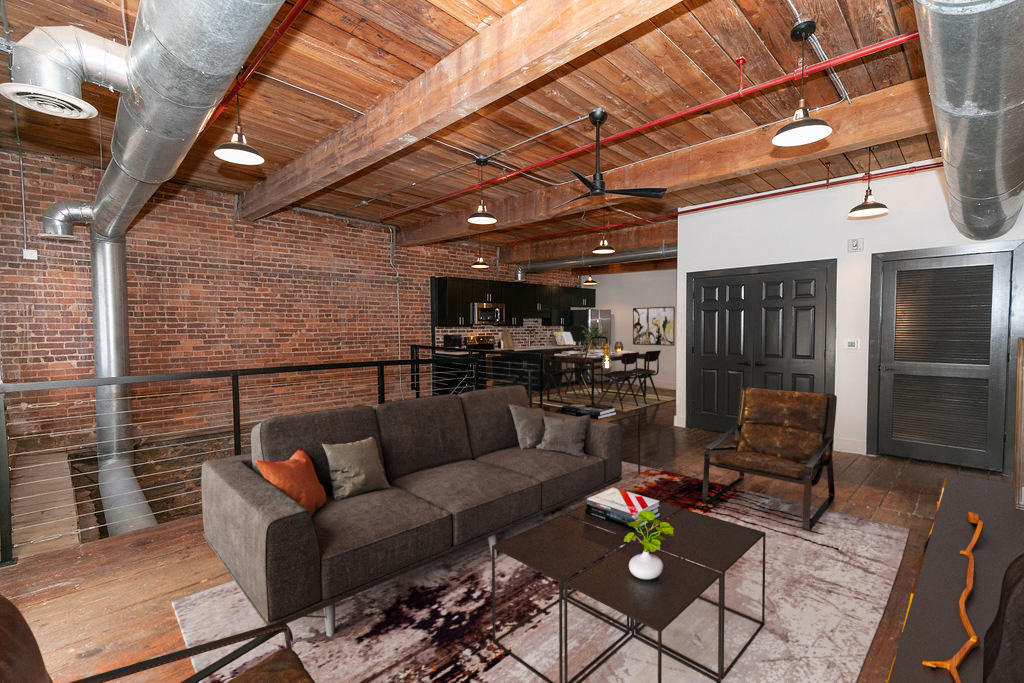 a living room with a couch and a table in a loft
