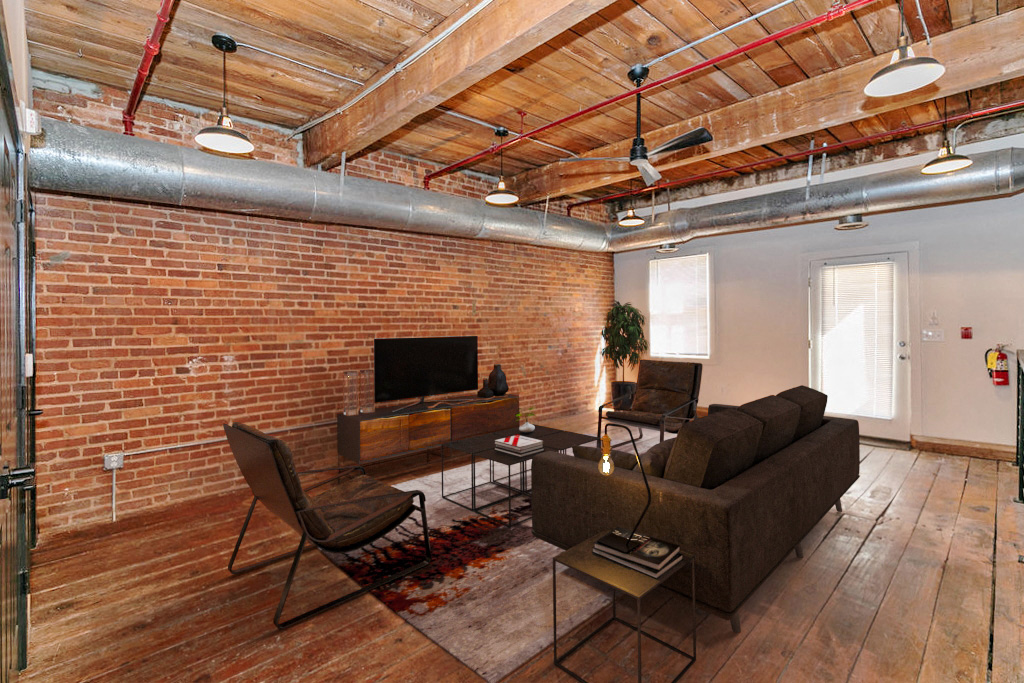 a living room with a brick wall and a couch