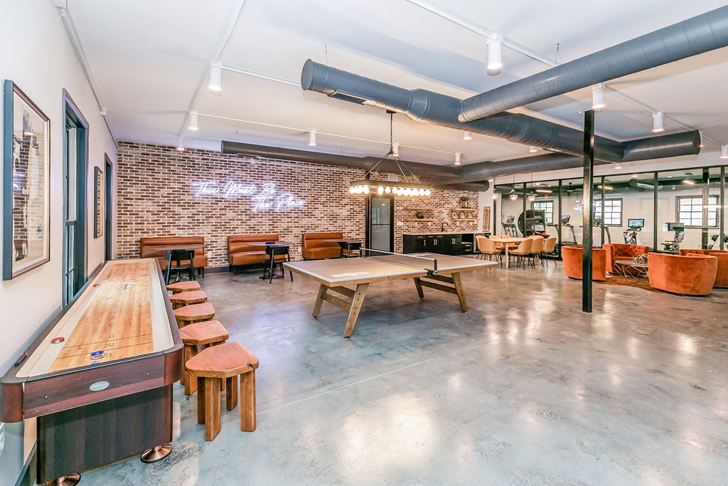 a large room with tables and chairs and a pool table