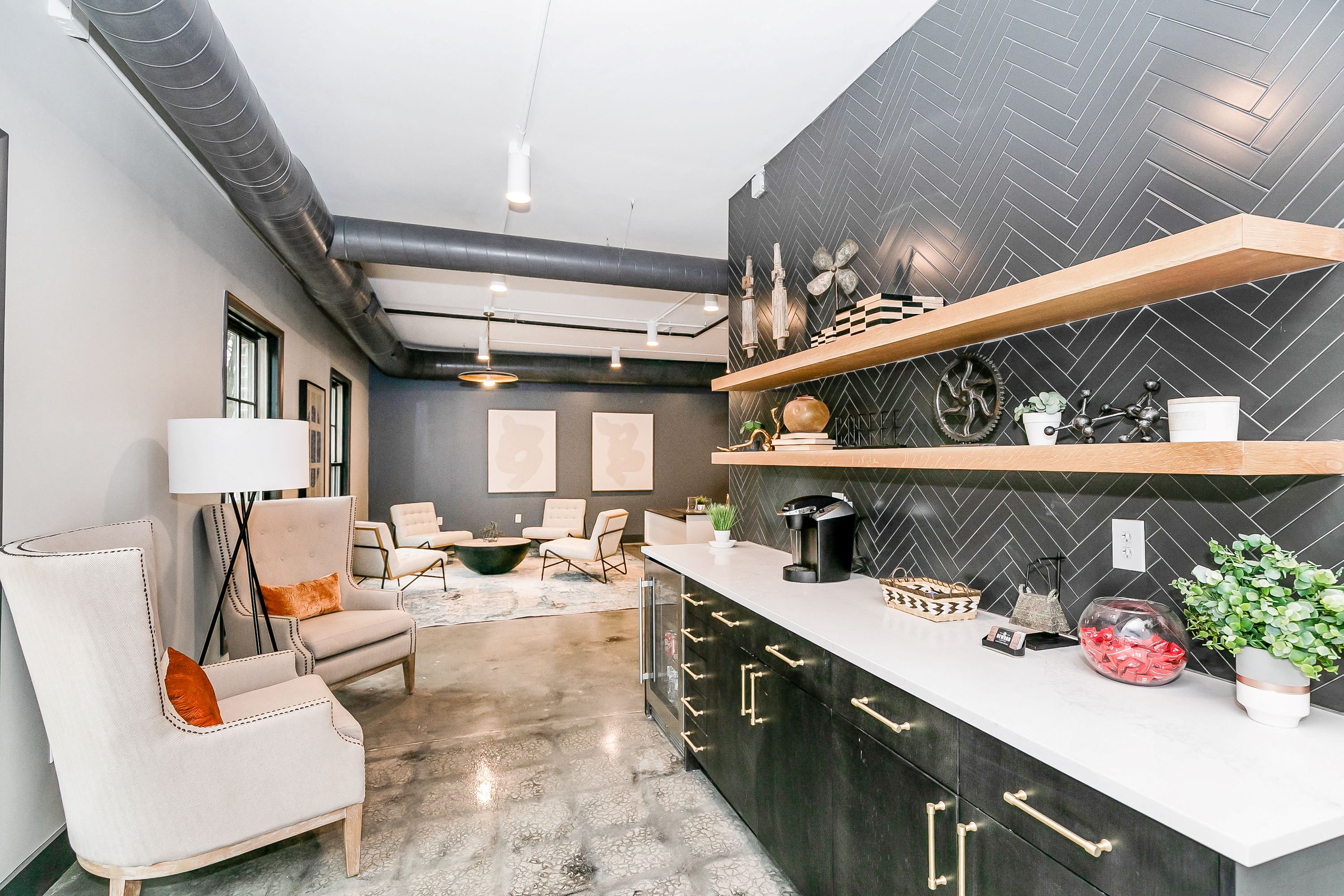 a kitchen with a counter and a living room with a couch and a table