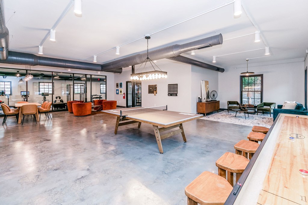 a large room with a ping pong table and a pool table