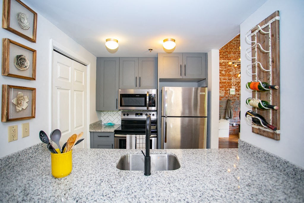 a kitchen with stainless steel appliances and a counter top