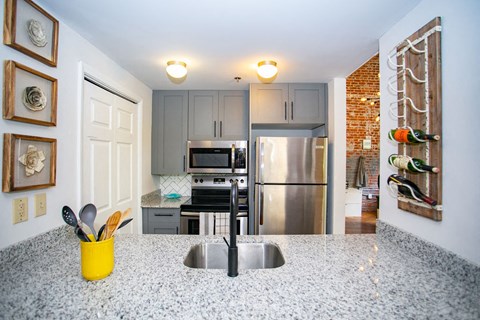 a kitchen with stainless steel appliances and a counter top