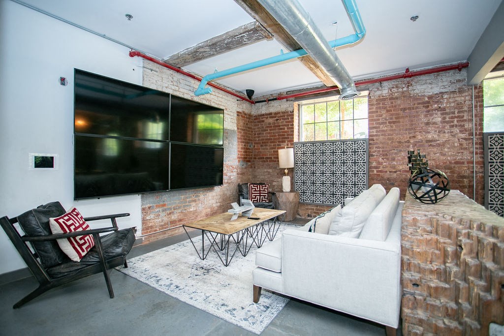 a living room with a white couch and a large television