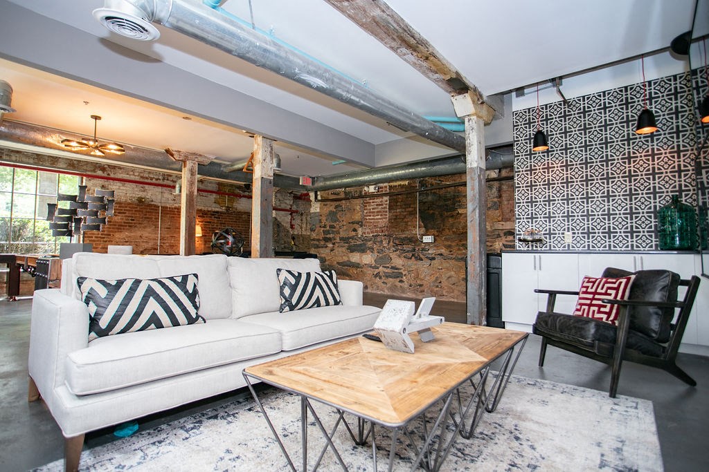 a living room with a white couch and a wooden table