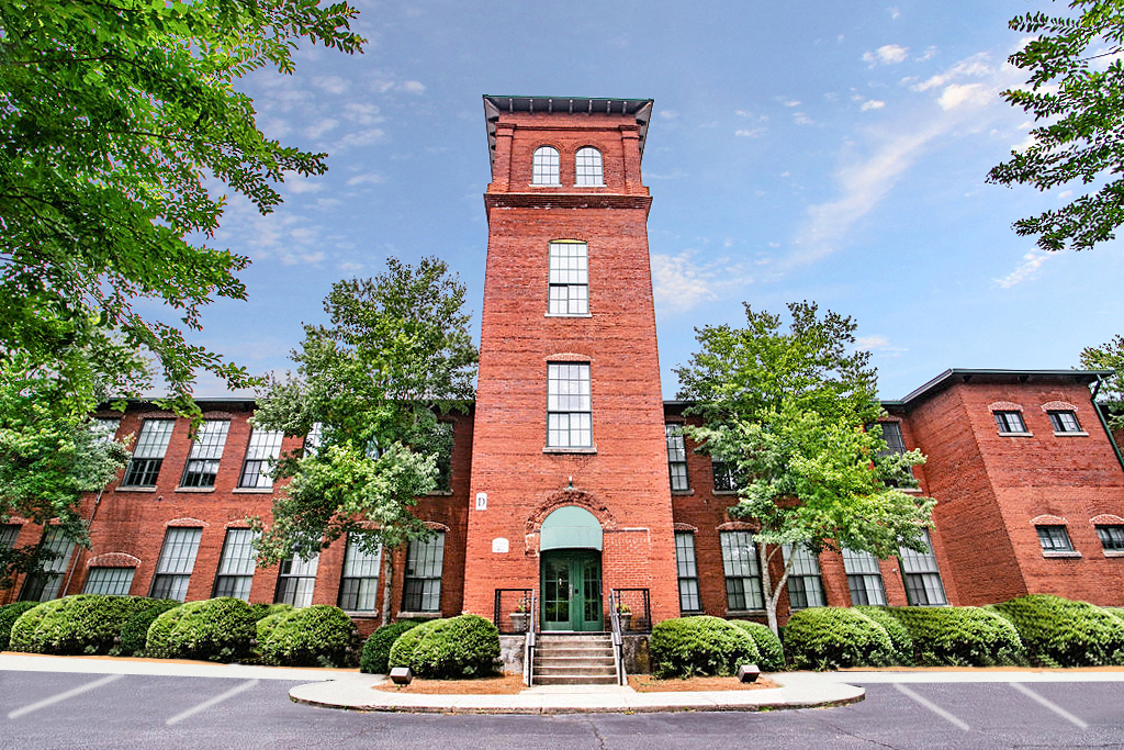 the facade of a brick building with a tall tower