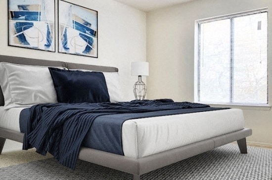 a black and white bedroom with a bed and a window