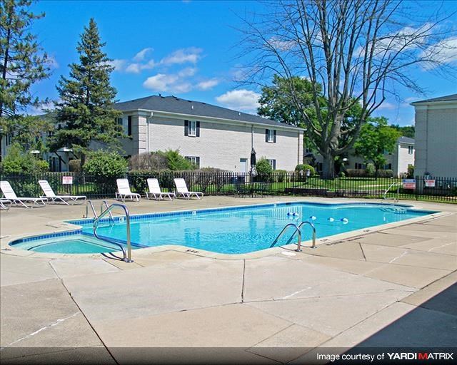 a swimming pool with a house in the background