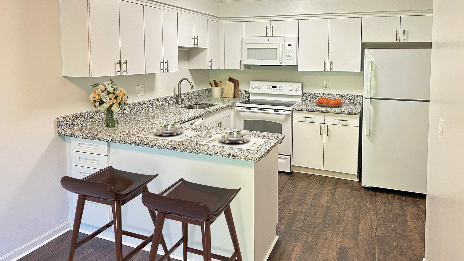 A kitchen with white cabinets and a granite countertop.