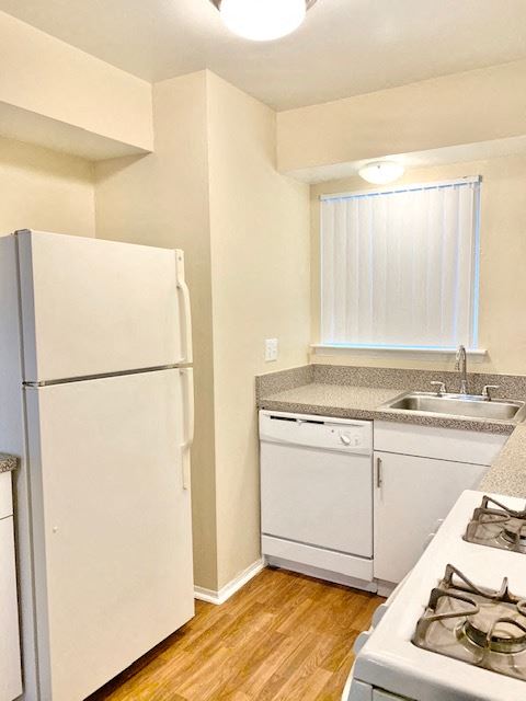 a kitchen with a refrigerator and a sink