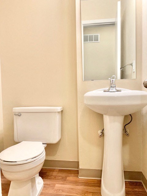 a bathroom with a toilet and a sink and a mirror