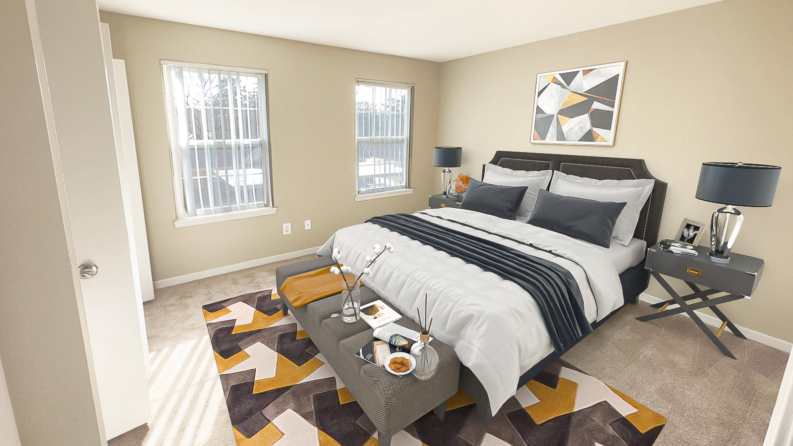 A bedroom with a large bed and a rug with a geometric pattern.