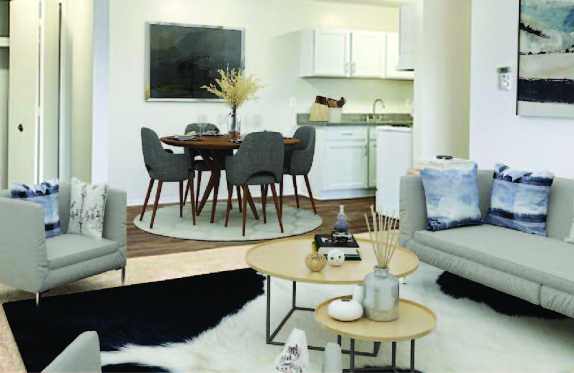 A modern living room with a dining table and grey couch.