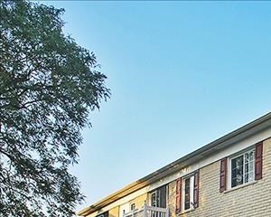 Reserved parking spaces included! a brick building with a balcony and a street