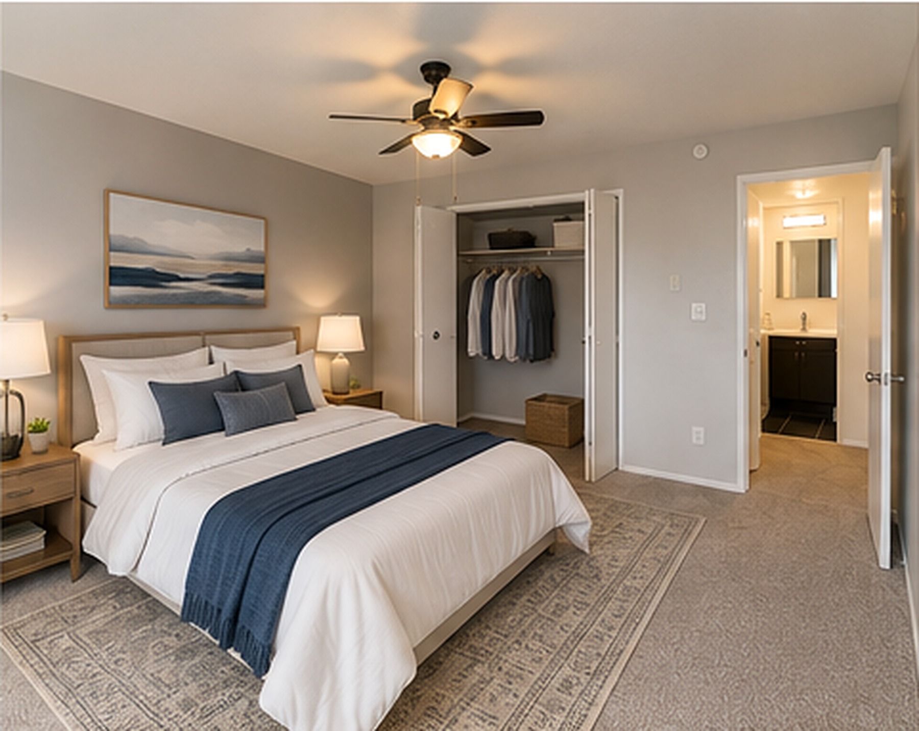 A bedroom with a large bed and a ceiling fan.