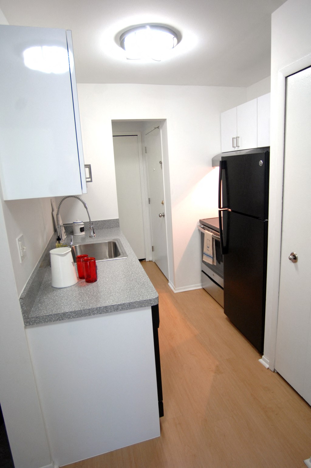 a small kitchen with a sink and a refrigerator