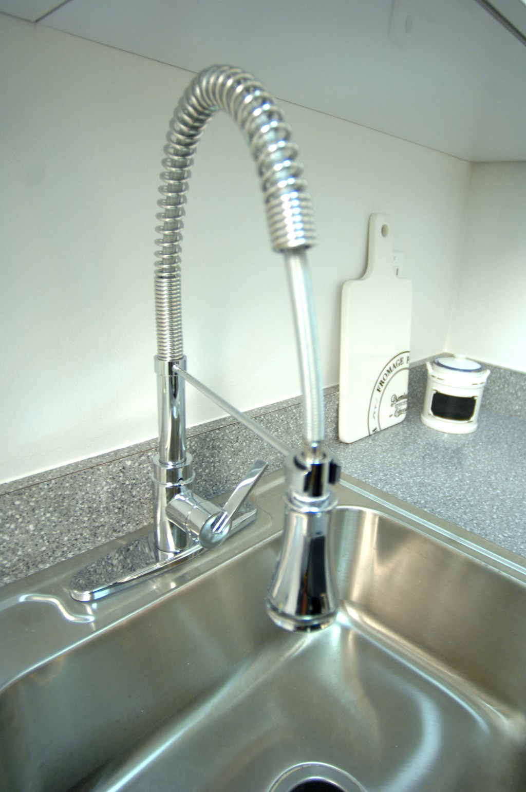 a kitchen sink with a faucet over it