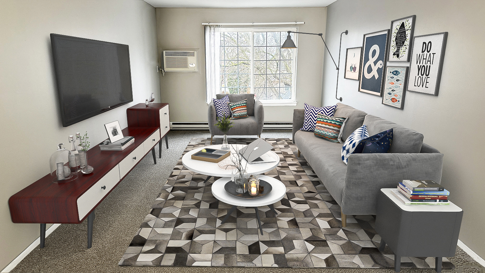 A living room with a grey couch, a coffee table, and a television.