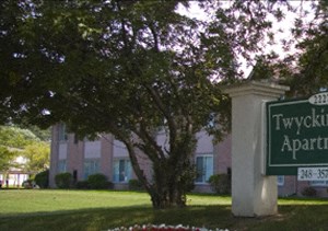 a flower bed of flowers in front of a sign