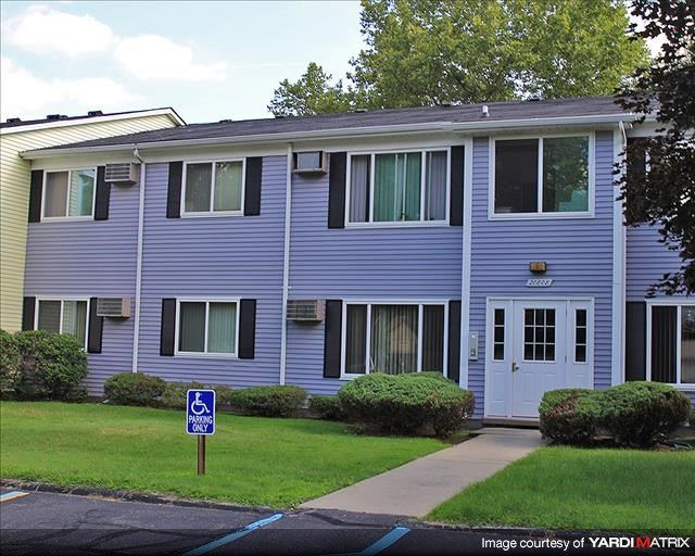 a purple house with a street sign in front of it