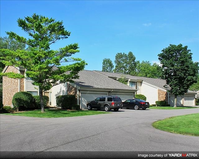 a house with two cars parked in the driveway