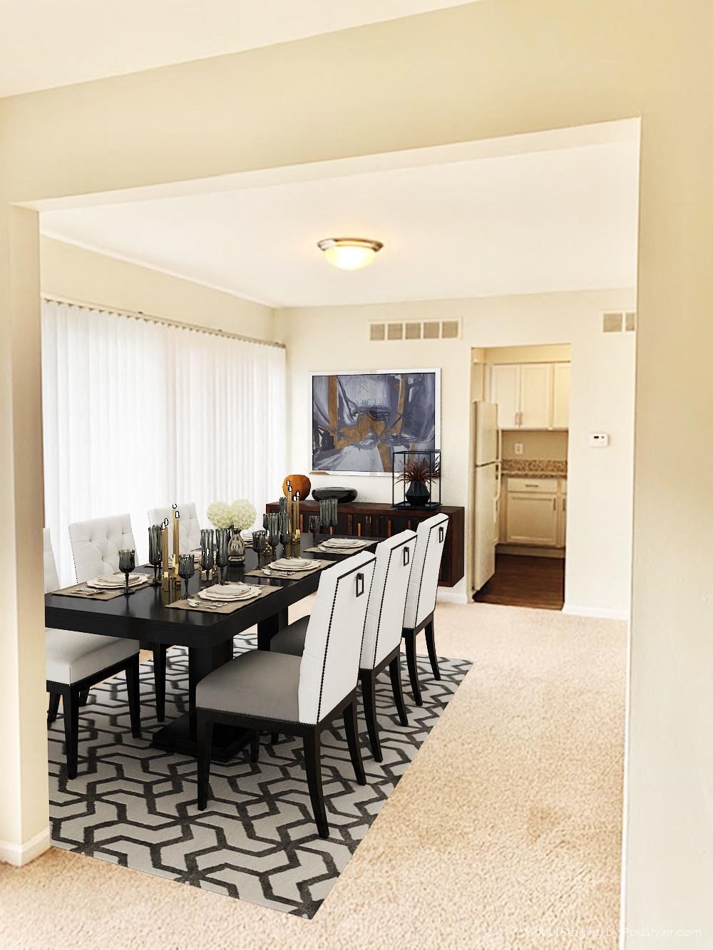 a dining room with a black table and chairs