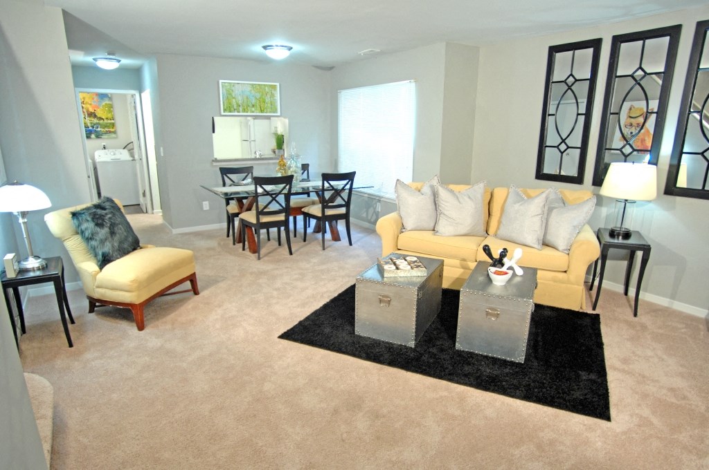 a living room with a couch and chairs and a table