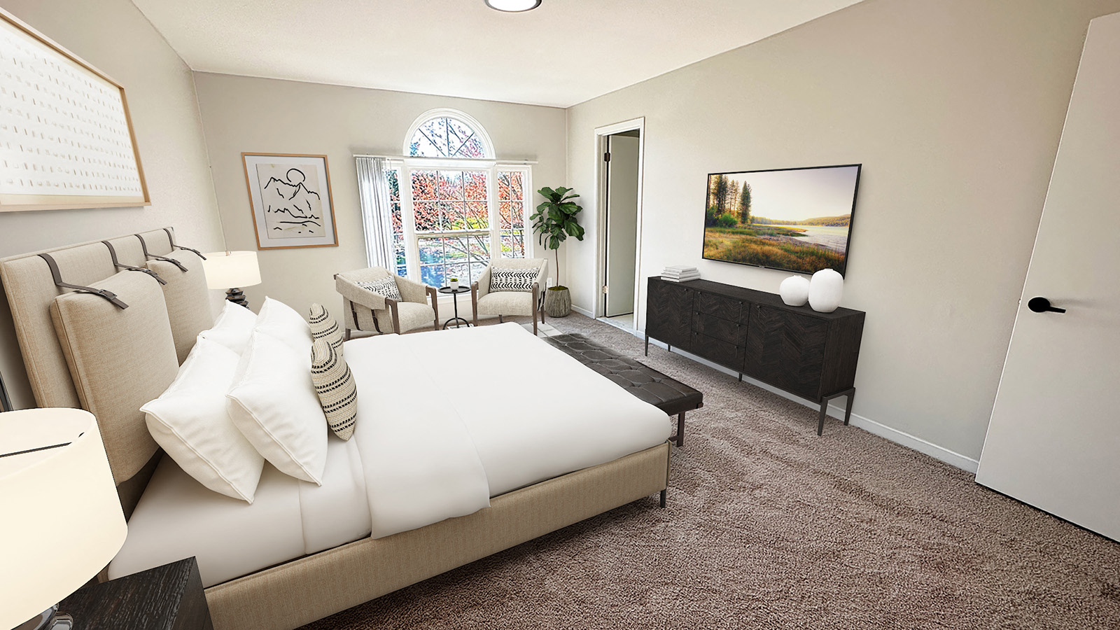 A living room with a large bed and a painting on the wall.