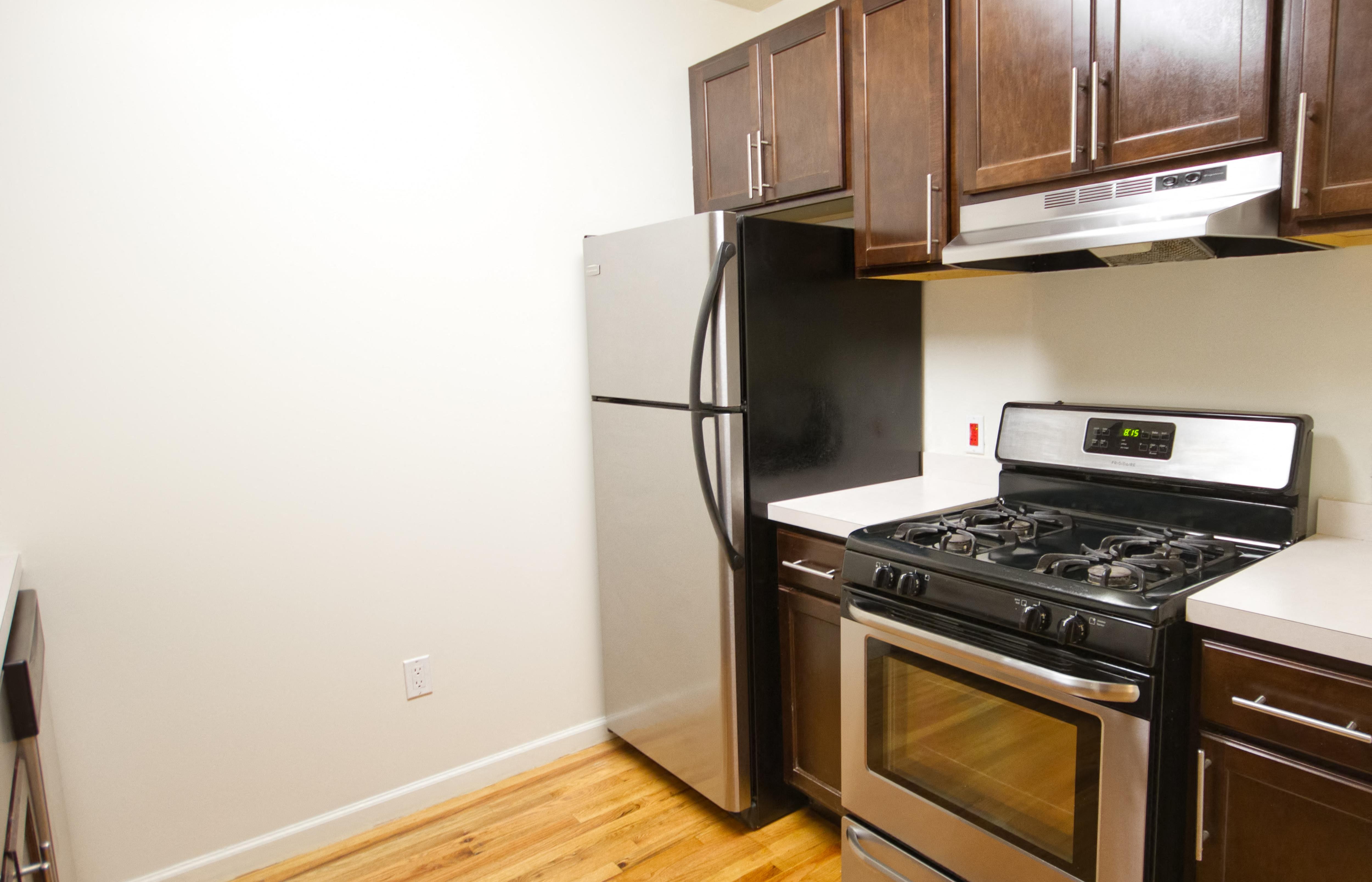 Kitchen with stainless steel appliances and dark wooden cabinets