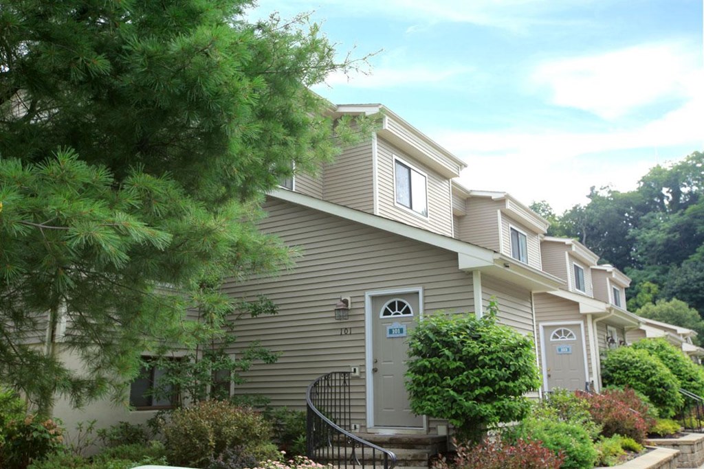 the front of a house with a porch and a door