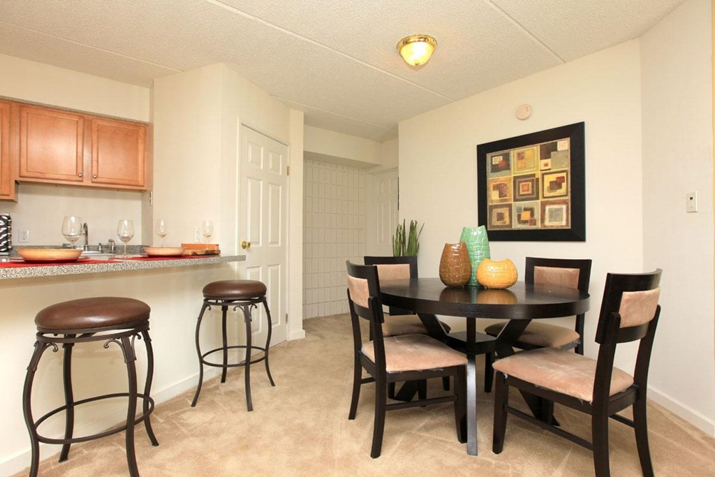 a dining room and kitchen with a table and chairs