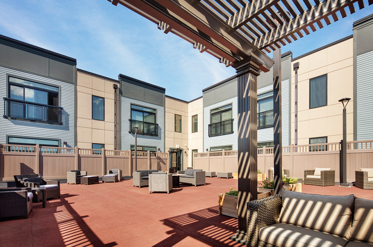 our apartments have a spacious courtyard with seating and a pergola
