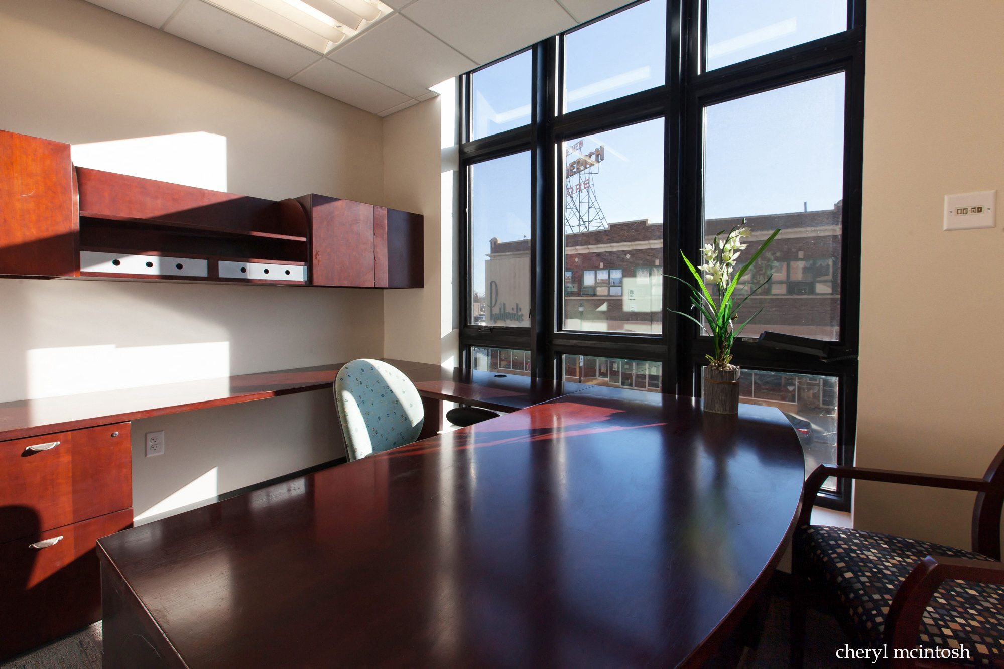 a conference room with a large window and a table and chairs