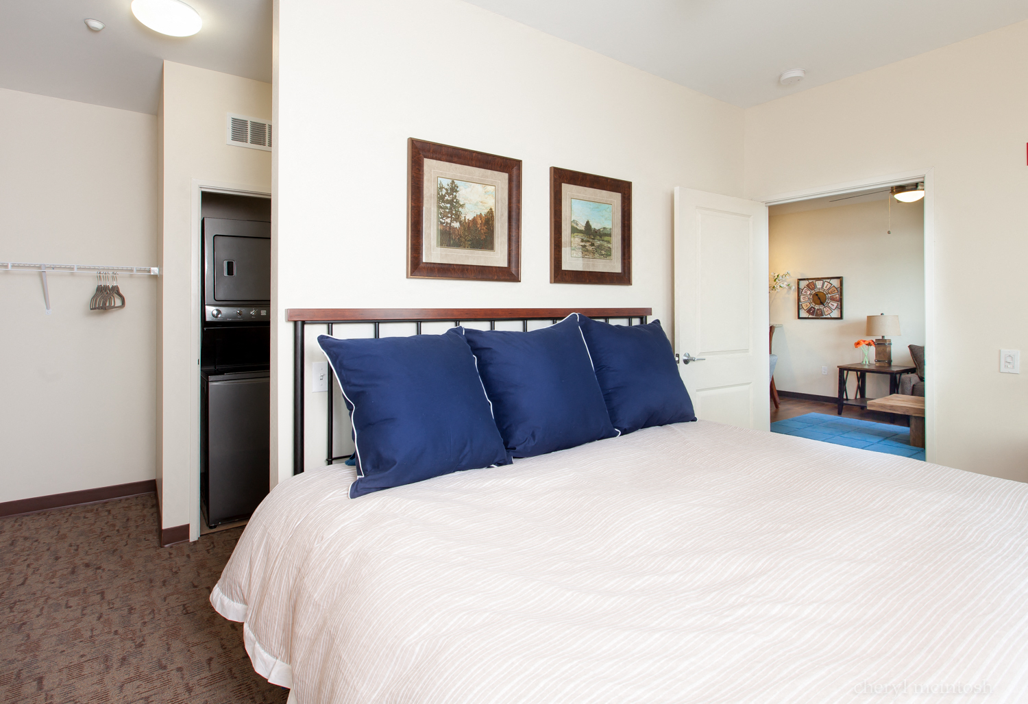 a bedroom with a bed with two blue pillows