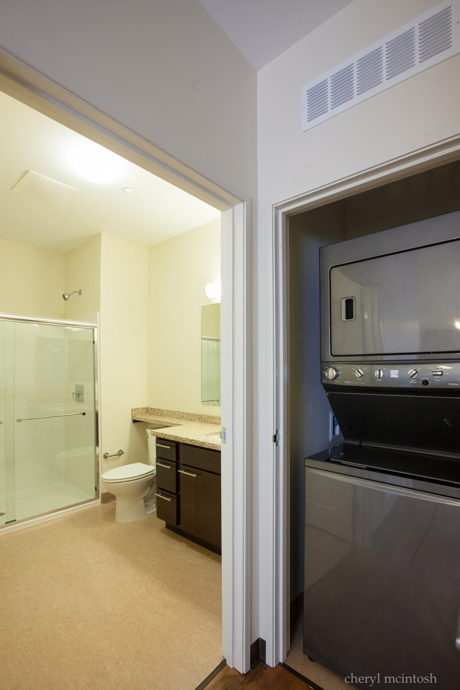 a view of a bathroom with a microwave and a sink and a toilet