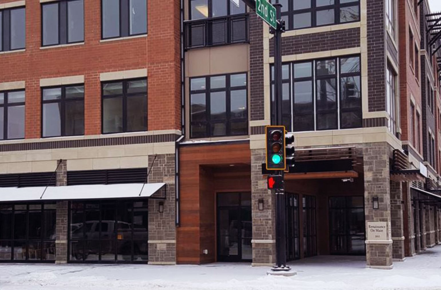 a green traffic light in front of a building