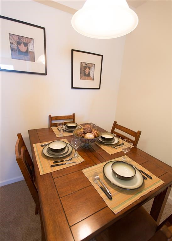 a wooden table with plates and bowls on it